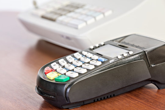 Close-up of credit card reader on the cash register background.