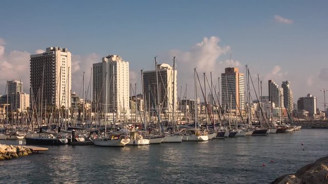 A  day time lapse of the yachts docked in the calm waters of the port of Tel Aviv in Israel