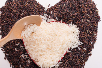 Heart shape from mix of jusmin rice and riceberry rice on white background
