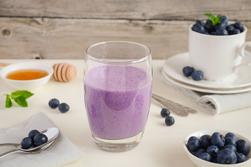 Blueberry and banana smoothie with oatmeal on the rustic wooden table, selective focus, copy space