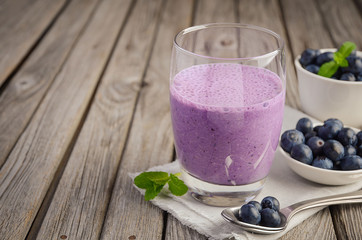 Blueberry and banana smoothie with oatmeal on the rustic wooden table, selective focus, copy space