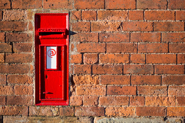 Red British mailbox with email sign on it