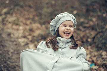 Little girl in autumn park