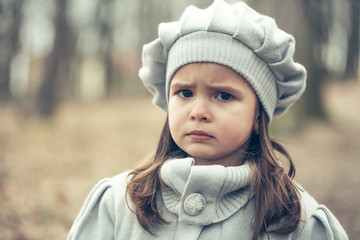 Little girl in autumn park