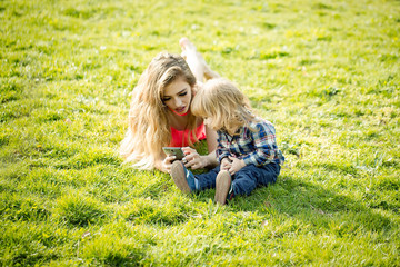 Fototapeta premium Girl and small boy on grass