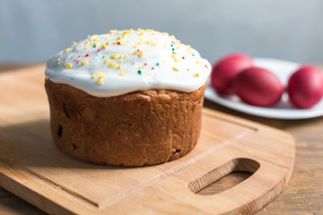 Easter cake on the plate on the wooden table