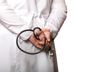 The doctor put his hands with stethoscope behind his back on a w