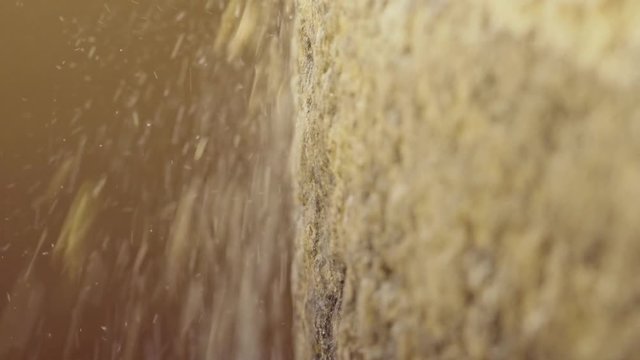 Macro shot of historic hand-driven millstone grinding wheat