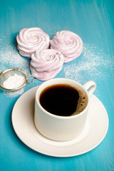 Fresh pink homemade zephyr - marshmallow and white cup of tea on