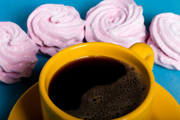 Fresh pink homemade zephyr - marshmallow and cup of coffee on bl