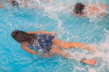 Children swim in pool underwater, happy active girls have fun in water
