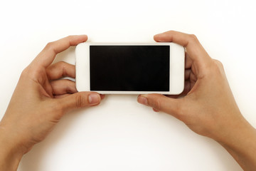 Two female hands holding mobile phone, smartphone, on white