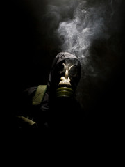 Man in gasmask with abstract smoke
