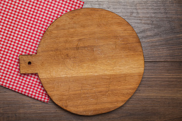 Empty round cutting board on a wooden table.Top view