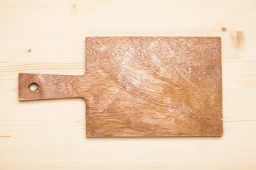 Wooden chop board on rustic wooden table top. Top view.