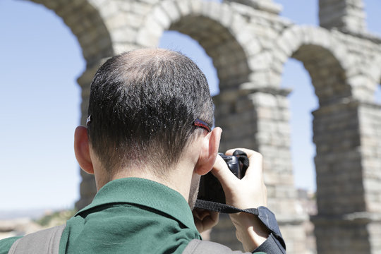 Photographer taking a picture of the Aqueduct of Segovia, Castile and Leon, Spain