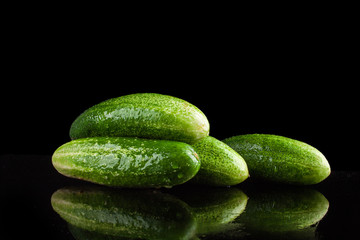 gherkins on a black background