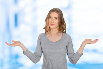 young woman with arms out shrugs shoulders