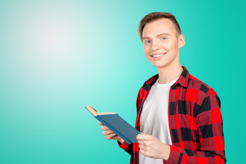 Handsome young man holding books
