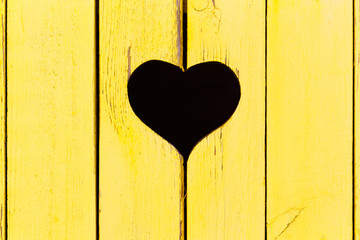 wooden background from old boards with a window in the shape of heart

