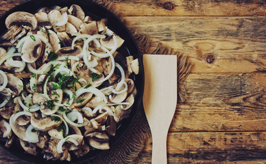 fresh sliced champignon and onions in frying pan