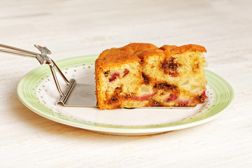 Piece of pear cake with chocolate and cherries