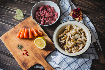 meat, mushrooms, tomatoes, vegetables and spices lie 