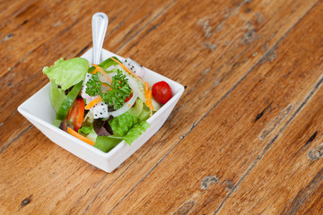 Fresh healthy salad on wooden table