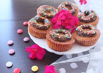 pumpkin cupcakes with chocolate cream and colored sprinkles