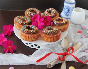 pumpkin cupcakes with chocolate cream and colored sprinkles