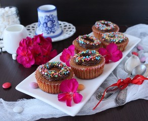 pumpkin cupcakes with chocolate cream and colored sprinkles