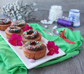 pumpkin cupcakes with chocolate cream and colored sprinkles