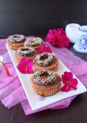 pumpkin cupcakes with chocolate cream and colored sprinkles