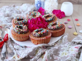 pumpkin cupcakes with chocolate cream and colored sprinkles