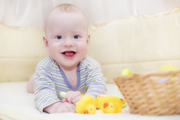 Smiling baby with toys