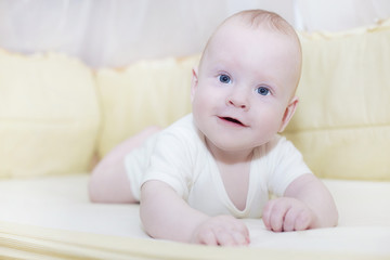 Lying baby in his bed