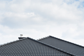 Black roof against cloudy sky