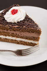 Chocolate birthday cake on a black background