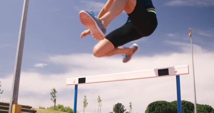Sportswoman doing hurdle race