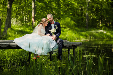 wedding couple  in the woods near the lake. 