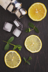 Obraz na płótnie Canvas lemon, orange, kiwi, mint on a black background. ingredients for lemonade