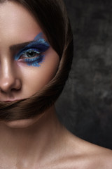 Half Face of beauty Model with blue Makeup on Eyes