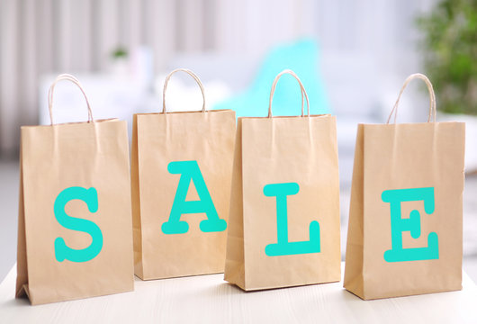 Word sale made with paper bags on blurred background