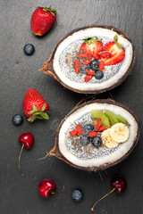 Chia seeds coconut pudding with berries and fruits, top view