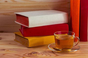 Cup of tea and books onwooden background