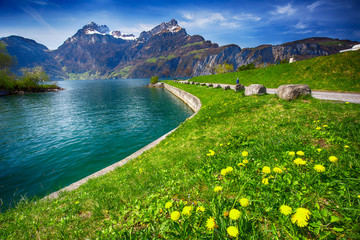 Beautiful sea promenade in Sisikon village with the view of Swiss Alps, Switzerland