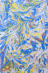 traditional Turkish Ebru technique. painting on water, followed by paper prints. Red ans blue bubbles and red flower