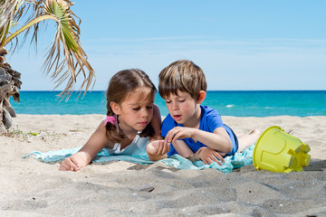 boy and girl playing on the beach