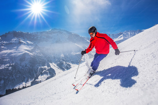 Young happy man skiing in Lenzerheide ski resort, Switzerland
