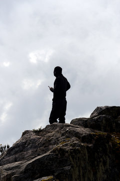silhouette of single person on suimmit in ruwenzori mountains, uganda